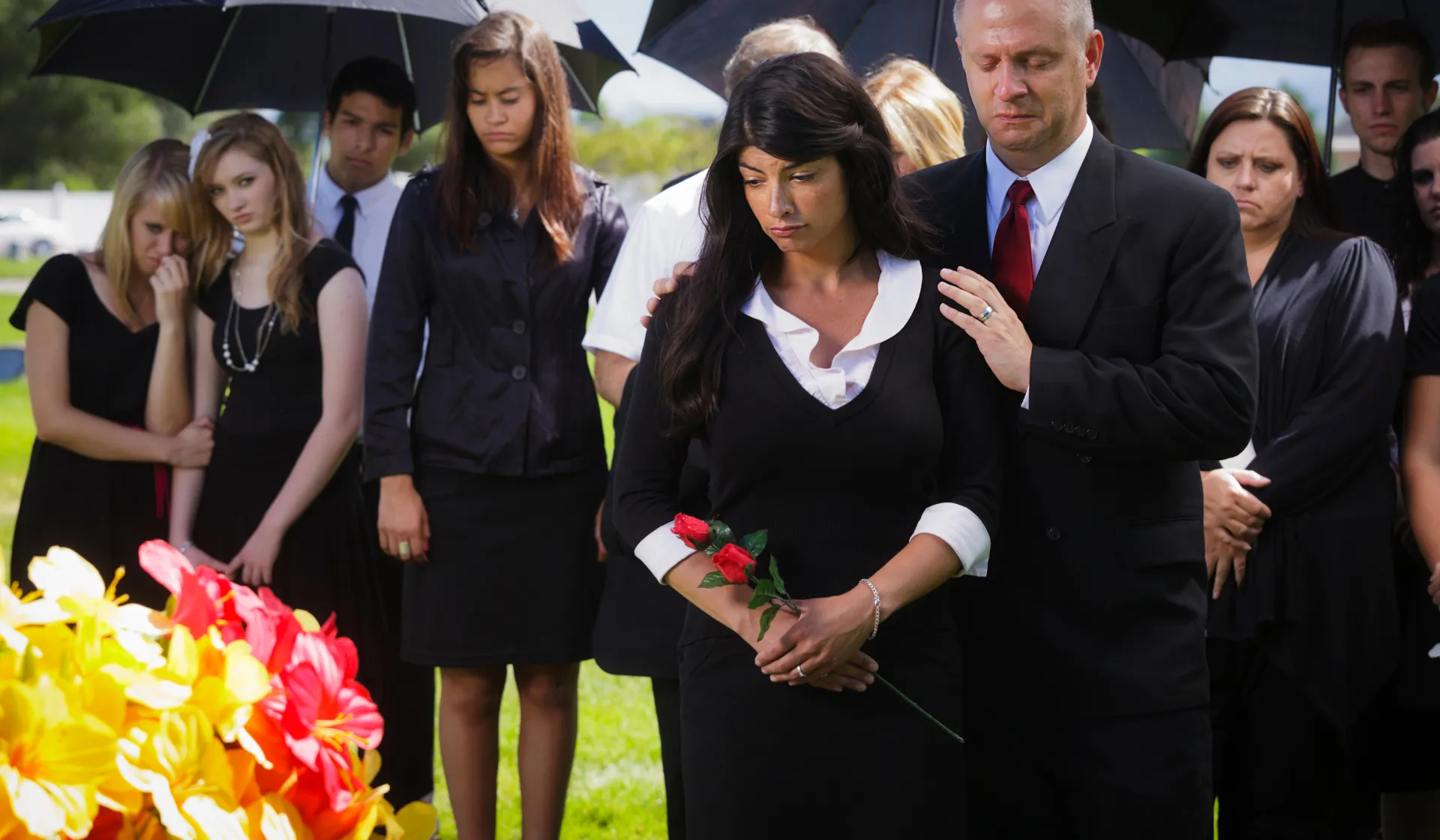 A funeral home director sitting at a desk reviewing a digital lead generation dashboard showing pre-planning inquiries and at-need call tracking from Google Ads and Facebook campaigns